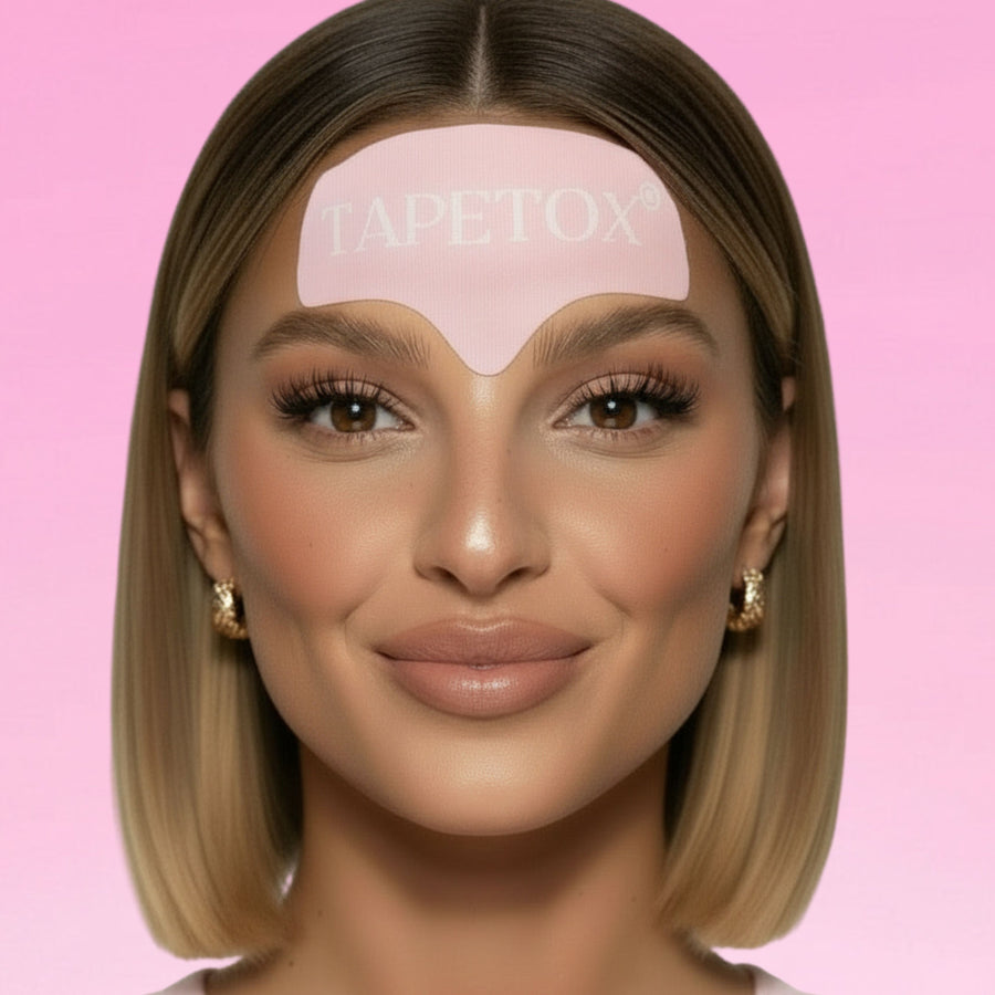 A smiling woman showcases a pink TAPETOX anti-wrinkle forehead patch against a soft pink background.