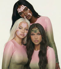 Three diverse models showcase pink heart-shaped and camouflage TAPE TOX face patches while posing in coordinated gradient shirts for a beauty skincare advertisement.